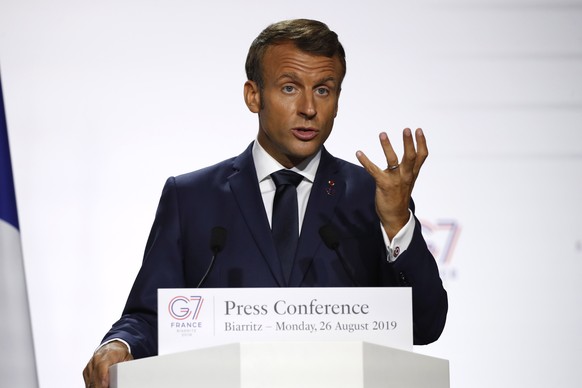 epa07794866 French President Emmanuel Macron attends a joint press conference that focused on climate during the G7 summit Monday, Aug. 26, 2019 in Biarritz. The G7 Summit runs from 24 to 26 August in ...