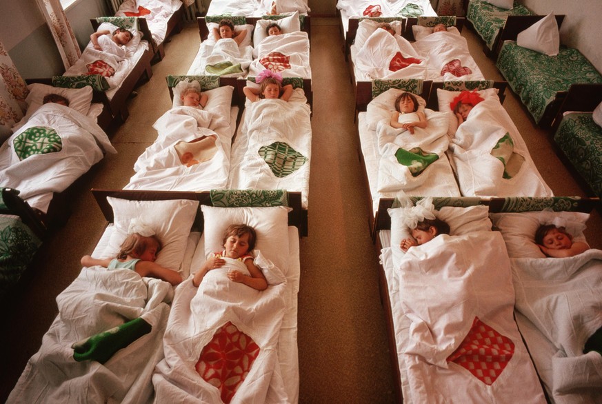 Little girls curl up for their naps at the Lenin Collective Farm's day care center, where they are looked after while their parents are working. | Location: Near Stavropol, USSR. (Photo by © Wally McN ...