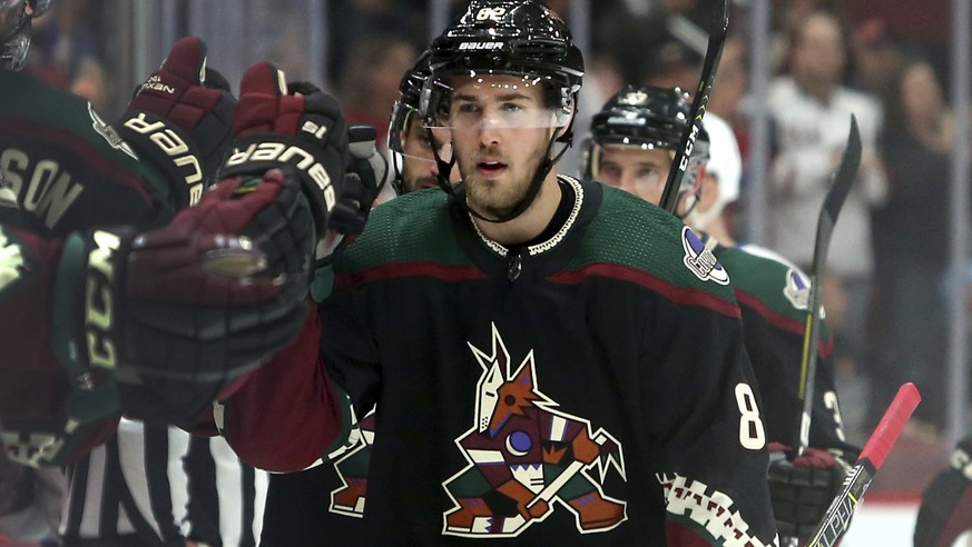 Arizona Coyotes&#039; Jordan Oesterle (82) is congratulated by teammates after scoring a first-period goal against the Tampa Bay Lightning during an NHL hockey game, Saturday, Oct. 27, 2018, in Glenda ...