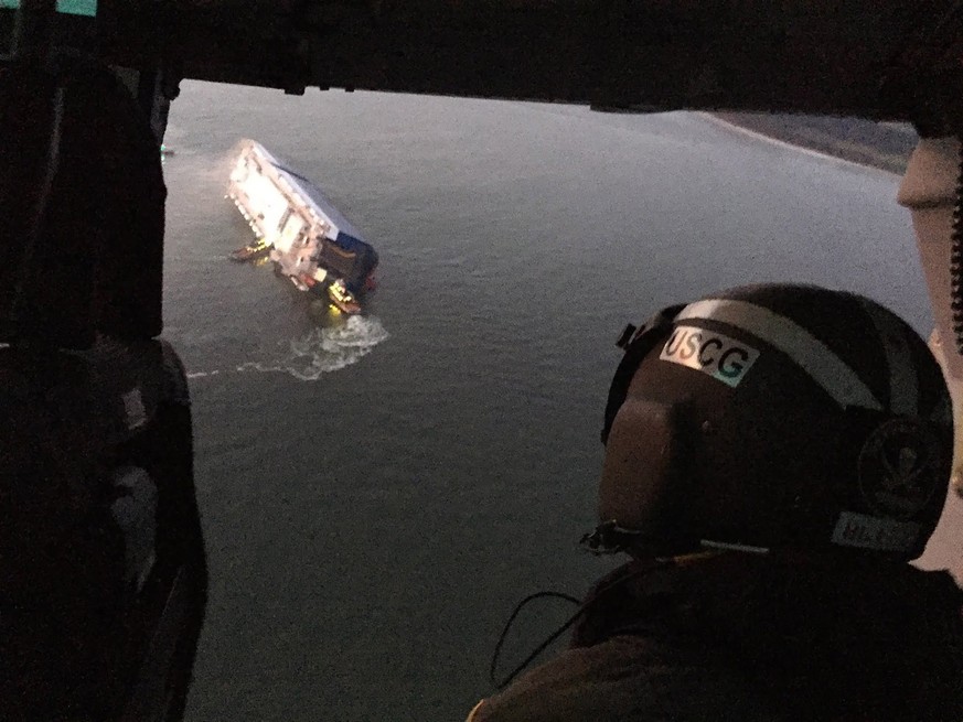 epa07828086 A handout photo made available by the US Coast Guard showing a Coast Guard crews and port partners responding to a disabled cargo vessel with a fire on board in St. Simons Sound, Georgia,  ...