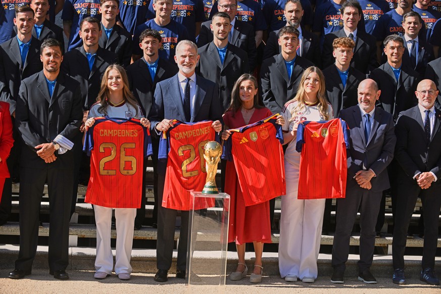 Spain's King Felipe VI and Queen Letizia, accompanied by Princess Leonor, left, and Infanta Sofia, right, pose with players from Spain's national soccer team at Zarzuela Palace in Madrid on  ...