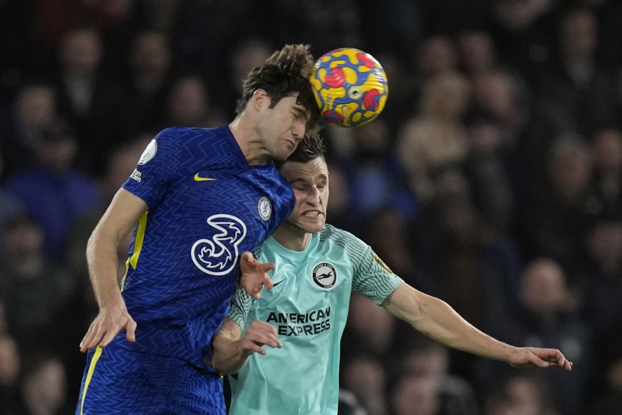 Chelsea&#039;s Marcos Alonso, left, heads the ball past Brighton&#039;s Joel Veltman during the English Premier League soccer match between Chelsea and Brighton at Stamford Bridge Stadium in London, E ...