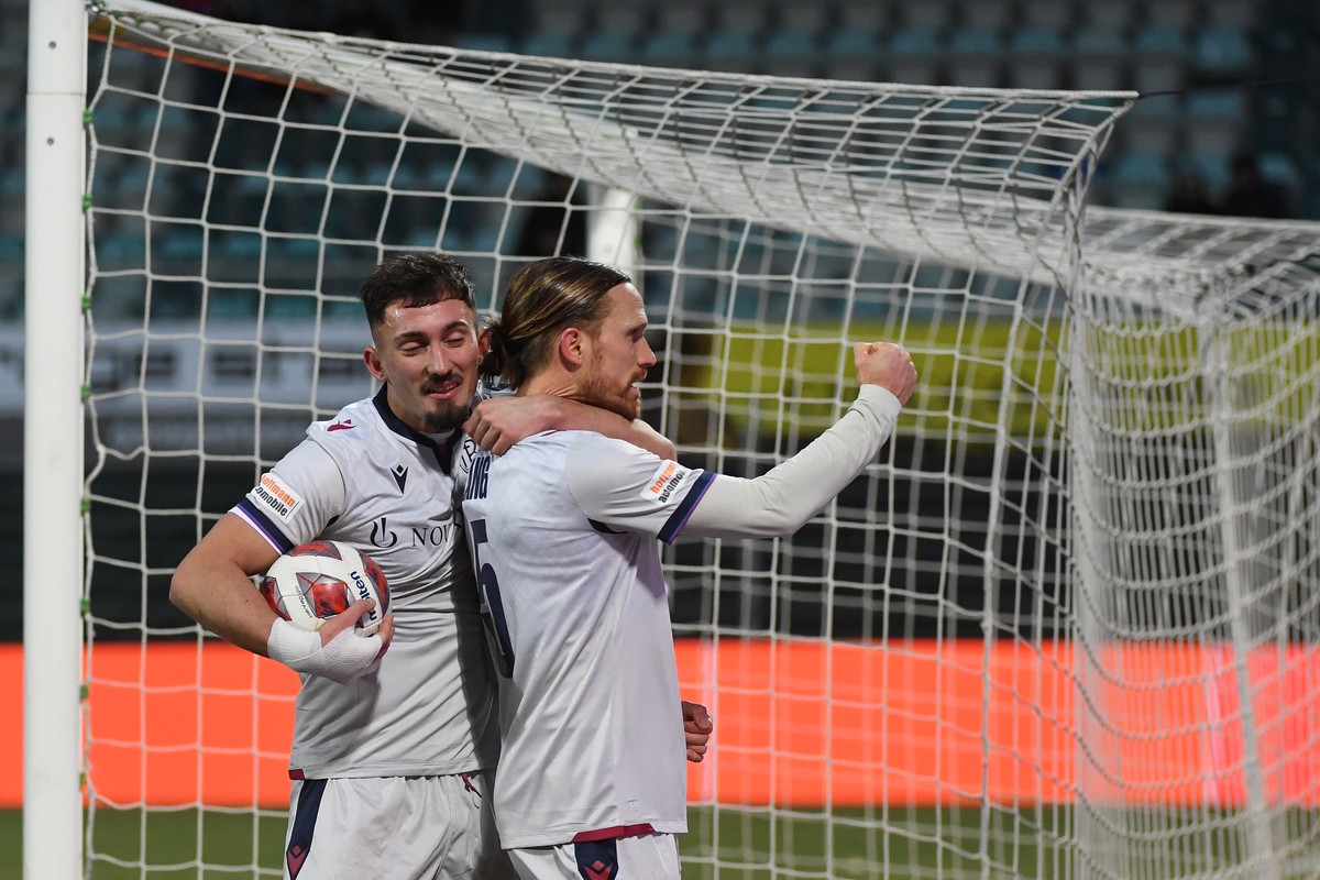 Basel's player Andi Zeqiri and Basel's player Michael Lang, right, celebrate the 2-2 goal, during the Super League soccer match FC Lugano against Basel FC, at the Cornaredo stadium in Lugano ...