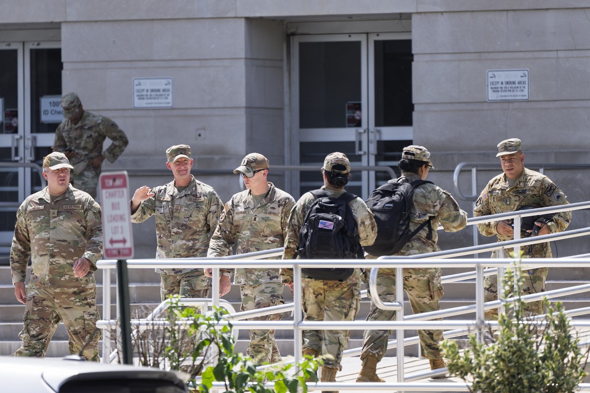 Military personnel arrive and depart at the District of Columbia National Guard Headquarters as President Donald Trump implements his order to use federal law enforcement and the National Guard to exp ...