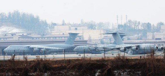 epa12798419 C-15 and C-17 U.S. transport aircraft are seen at Osan Air Base in Pyeongtaek, South Korea, 06 March 2026. U.S. troops stationed in South Korea have relocated Patriot missile defense batte ...