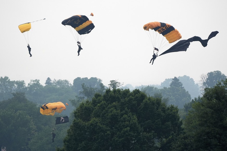 Members of the U.S. Army Parachute Team Golden Knights make their landing during an event to honor the Army's 250th anniversary, coinciding with President Donald Trump's 79th birthday, Satur ...