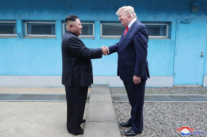 In this Sunday, June 30, 2019, photo provided by the North Korean government, North Korean leader Kim Jong Un, left, and U.S. President Donald Trump shake hands over the military demarcation line at t ...