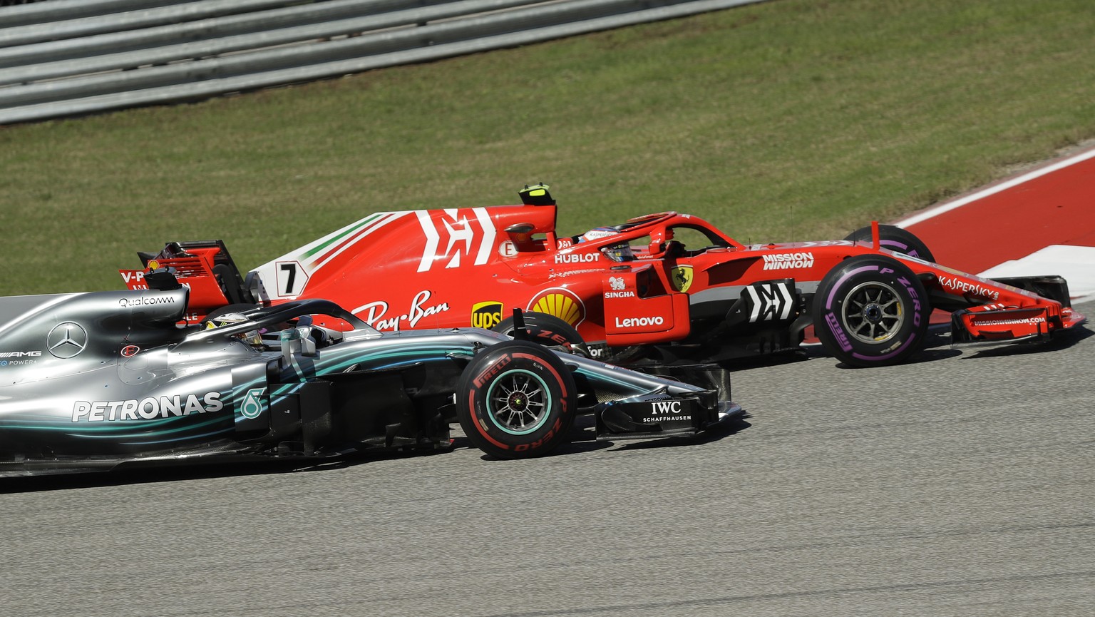 Ferrari driver Kimi Raikkonen, of Finland, passes Mercedes driver Lewis Hamilton, of Britain, during the Formula One U.S. Grand Prix auto race at the Circuit of the Americas, Sunday, Oct. 21, 2018, in ...