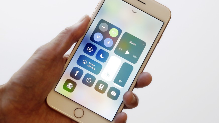 In this Sept. 15, 2017, photo, the iOS 11 control center is displayed on the iPhone 8 Plus in New York. The control center offers easy access to the flashlight and other tools with a swipe up from the ...