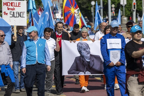 epa09943957 People carry placards and bannrers as they are demonstrating to support the Uyghurs against the High Commissioner for Human Rights&#039; failure to listen to the communities concerned, mai ...