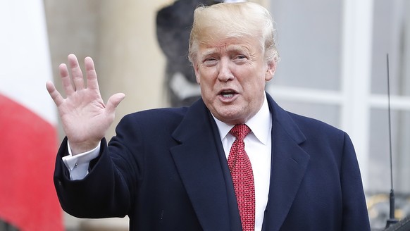 epa07155168 US President Donald J. Trump gestures as he leaves the Elysee Palace following his meeting with French President Emmanuel Macron (not pictured) in Paris, France, 10 November 2018. US Presi ...