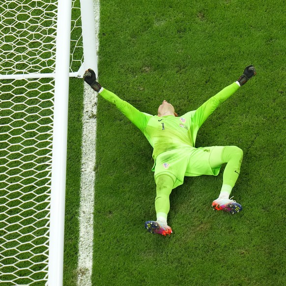 Croatia's goalkeeper Dominik Livakovic celebrates after Brazil's Marquinhos missed a penalty shot during the World Cup quarterfinal soccer match between Croatia and Brazil, at the Education ...
