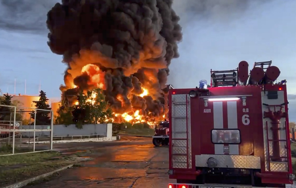 epa10598084 A still image taken from a handout video made available by the Governor of Sevastopol's Telegram channel shows firefighters deployed to extinguish a fire at an oil depot in Sevastopol ...