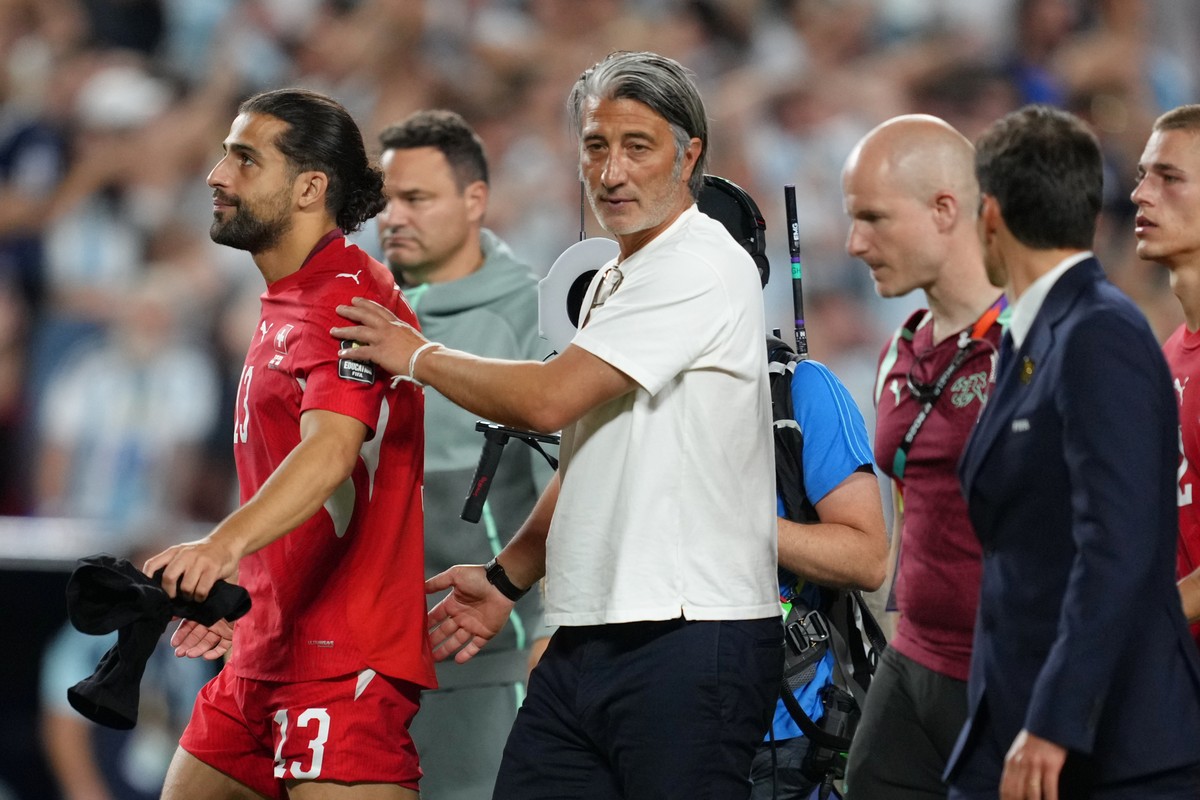 Switzerland head coach Murat Yakin and Switzerland's Ricardo Rodriguez (13) react after the World Cup quarterfinal soccer match between Argentina and Switzerland in Kansas City, Mo., Saturday, Ju ...