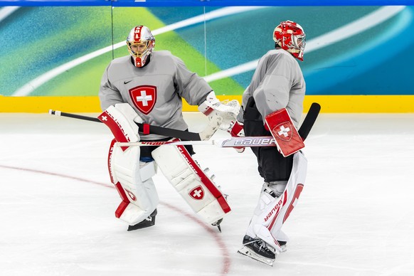 epa12717492 Switzerland's Leonardo Genoni, (L) and Switzerland's Reto Berra, (R) in action, during a training session of team Switzerland at the 2026 Olympic Winter Games in Milan Santa Giul ...