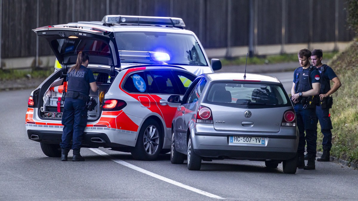 Police officers block a street near the Schachen horse racing track in Aarau following a shooting during a rave event at the Schachen horse racing track near Aarau, Switzerland on Sunday, August 30, 2 ...