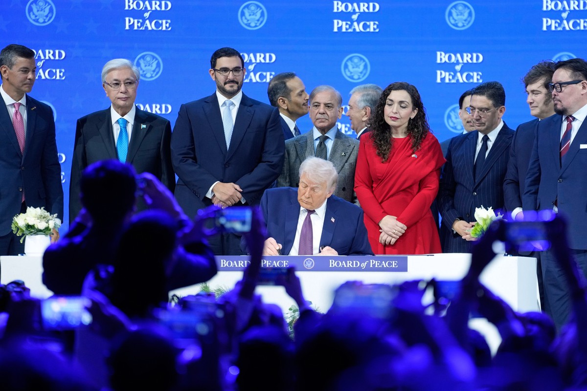 FILE - President Donald Trump signs the charter of his Board of Peace initiative at the Annual Meeting of the World Economic Forum in Davos, Switzerland, Jan. 22, 2026. (AP Photo/Markus Schreiber, Fil ...