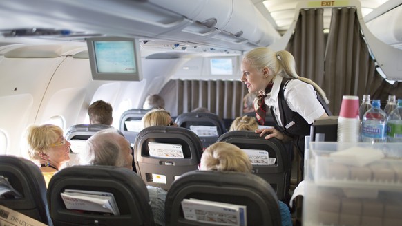 A flight attendant serves breakfast during the flight to Zurich, pictured on April 12, 2013, in an Airbus A319. The Airbus A319, an aircraft of Swiss International Air Lines, flies from Zurich to Oslo ...