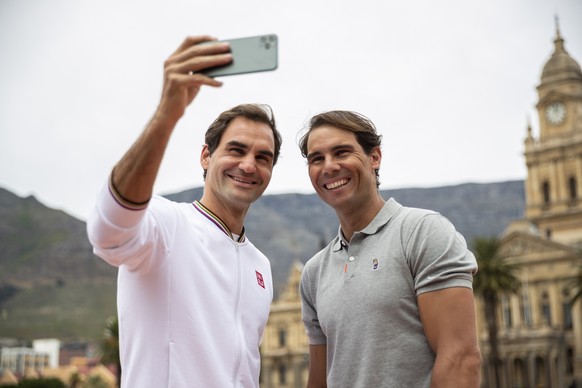 epa10185695 (FILE) - Roger Federer of Switzerland (L) and Rafael Nadal of Spain (R) take a selfie after playing mini tennis on the Cape Town Grand Parade infront of the City Hall and Table Mountain ah ...