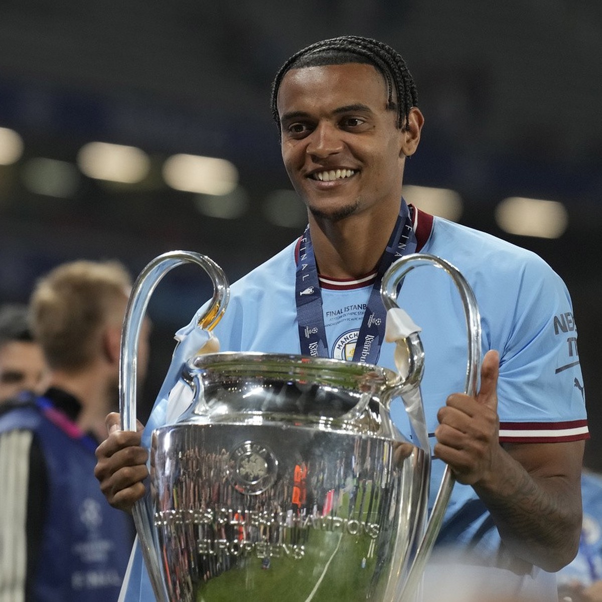 Manchester City's Manuel Akanji celebrates with the trophy after winning the Champions League final soccer match between Manchester City and Inter Milan at the Ataturk Olympic Stadium in Istanbul ...