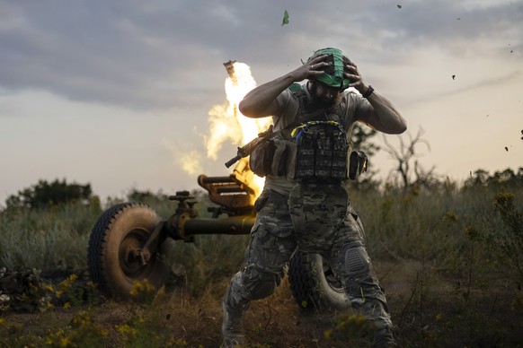 A Ukrainian serviceman of the 3rd Assault Brigade fires a 122mm mortar towards Russian positions at the front line, near Bakhmut, Donetsk region, Ukraine, Sunday, July 2, 2023. (AP Photo/Alex Babenko)