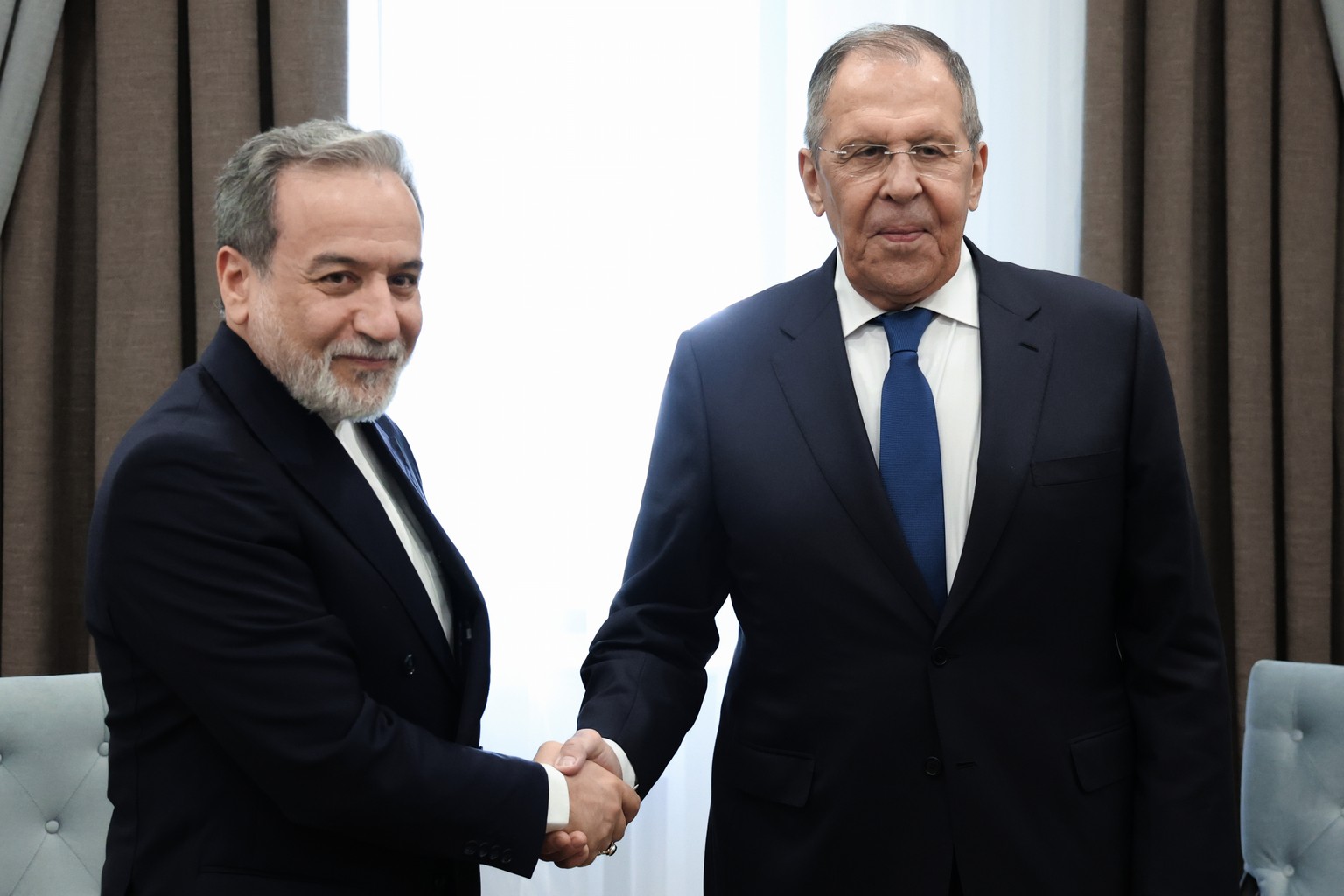In this photo provided by Russian Foreign Ministry Press Service, Russian Foreign Minister Sergey Lavrov, right, and Iranian Foreign Minister Abbas Araghchi, pose for a photo on the sidelines of a mee ...