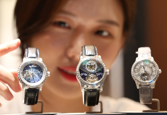 epa07704785 A model look at three kinds of Swiss watchmaker Jaeger-LeCoultre&#039;s luxury watches, including the Master Gyrotourbillon (C) set with 6.7 carats of diamonds, at a Seoul department store ...