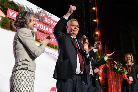 epa07507340 Social Democratic Party leader Antti Rinne (C) and his wife Heta Ravolainen-Rinne (L) celebrate winning the election at the Social Democratic Party election night event at Virgin Oil Co. r ...