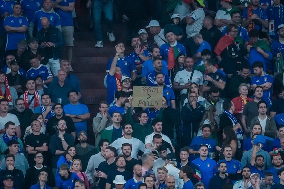 EURO 2024 - Matchday 2, Group B: Spain vs. Italy Italian fans hold a Pasta Paella sign during the EURO 2024 Day 2 Group B match between Spain and Italy on 20 June 2024, at Arena AufSchalke, in Gelsenk ...