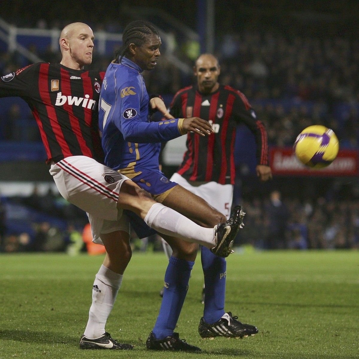 Portsmouth's Kanu, right, grapples with AC Milan's Philippe Senderos during their Group E, UEFA Cup, soccer match at the Fratton Park stadium, Portsmouth, England, Thursday, Nov. 27, 2008. ( ...