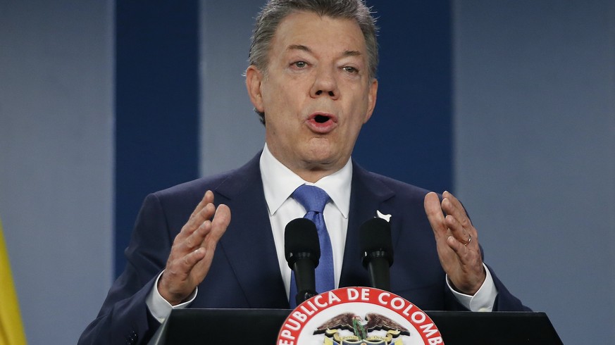 FILE - In this Wednesday, Oct. 4, 2016 file photo, Colombia’s President Juan Manuel Santos delivers a statement to the press after meeting with former President Alvaro Uribe and other opposition leade ...