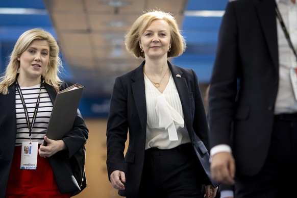 epa10221150 British Prime Minister Liz Truss (R) arrives for the Conservative Party Conference in Birmingham, Britain, 03 October 2022. The government announced a U-turn on scrapping the 45p tax rate, ...