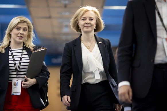 epa10221150 British Prime Minister Liz Truss (R) arrives for the Conservative Party Conference in Birmingham, Britain, 03 October 2022. The government announced a U-turn on scrapping the 45p tax rate, ...