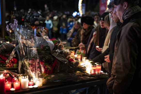 Several hundred mourners gather to lay down flowers and light candles to remember the victims of the fire at the "Le Constellation" bar and lounge leaving people dead and injured, during New ...