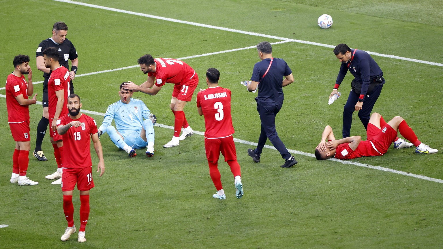 epa10317865 Goalkeeper Ali Beiranvand (down L) of Iran reacts during the FIFA World Cup 2022 group B soccer match between England and Iran at Khalifa International Stadium in Doha, Qatar, 21 November  ...