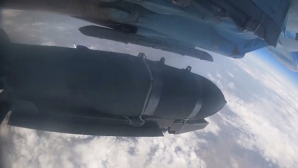 In this photo taken from video released by the Russian Defense Ministry on Wednesday, Aug. 14, 2024, a Su-34 bomber of the Russian air force drops FAB-500 bombs on Ukrainian positions at an undisclose ...