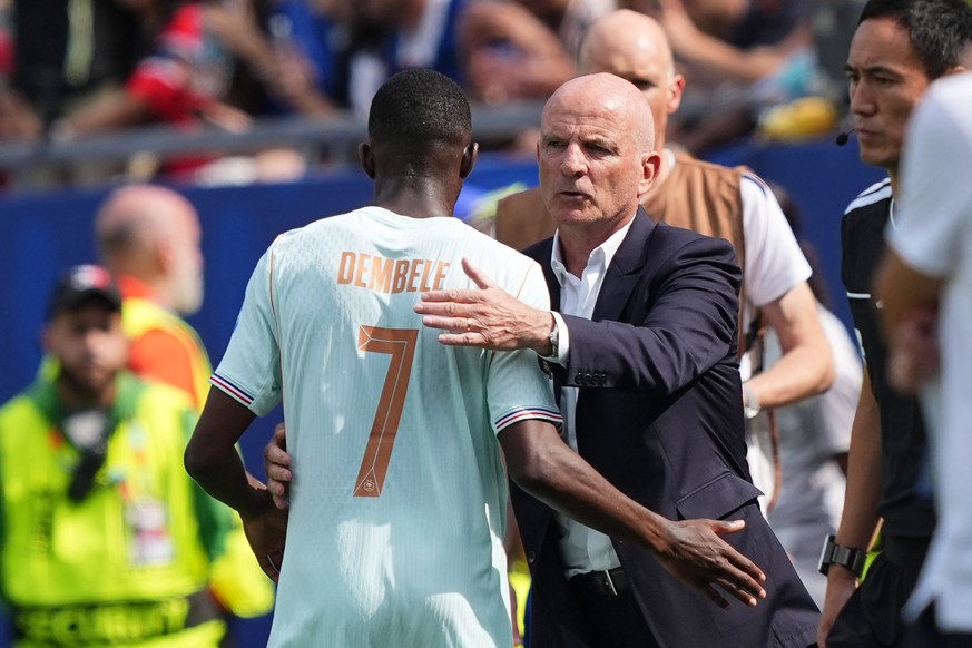 France assistant coach Guy Stephan embraces France's Ousmane Dembele after he was substituted during the World Cup Group I soccer match between Norway and France in Foxborough, Mass., near Boston ...