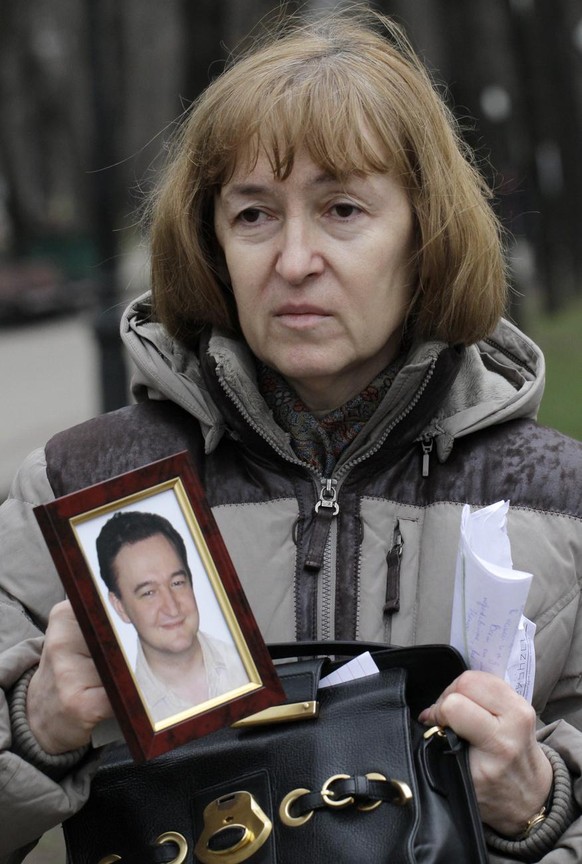 In this Monday, Nov. 30, 2009 file photo Nataliya Magnitskaya, mother of lawyer Sergei Magnitsky who died in jail, holds a photo of her son as she speaks during an interview with the AP in Moscow. U.S ...