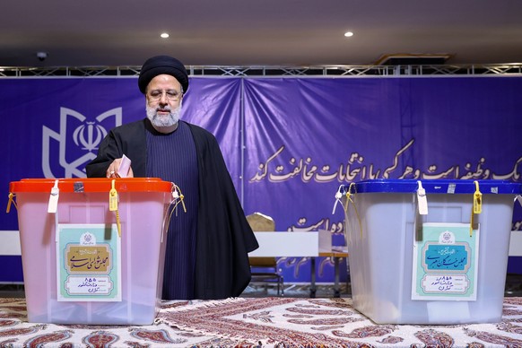 epa11190324 A handout photo made available by the Iranian presidency shows, Iranian president Ebrahim Raisi casting his vote during the Iranian legislative election in Tehran, Iran, 01 March 2024. Ira ...