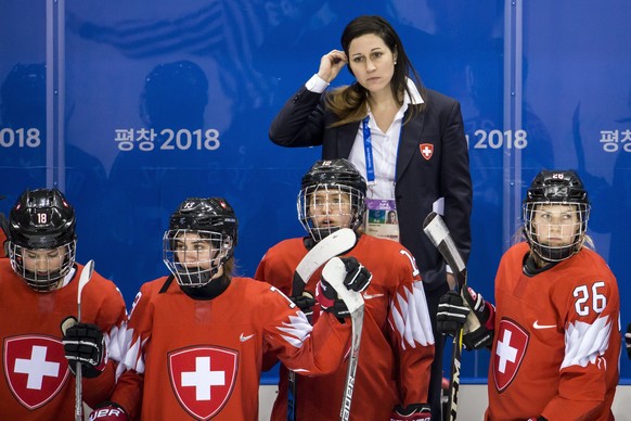 Tess Allemann of Switzerland, Sara Benz of Switzerland, Lisa Ruedi of Switzerland, Daniela Diaz, head coach of Switzerland, and Dominique Ruegg of Switzerland, from left, react after the women ice hoc ...