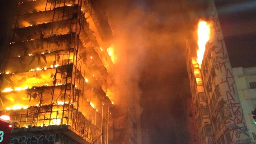 In this photo released by Sao Paulo Fire Department, a building on fire is seen in Sao Paulo, Brazil, Tuesday, May 1, 2018. A burning building in downtown Sao Paulo has collapsed as firefighters worke ...