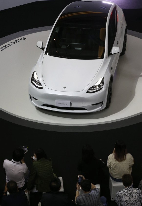 epa10353189 People view Tesla Model Y car during Tesla official launching event in Thailand, in Bangkok, Thailand, 07 December 2022. Tesla, after years of market research and preparations, officially  ...