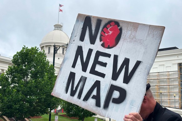 A demonstrator holds up a sign outside the Alabama Statehouse in Montgomery, Ala., on Thursday, May, 7 2026. (AP Photo/Kim Chandler)
Election 2026 Redistricting