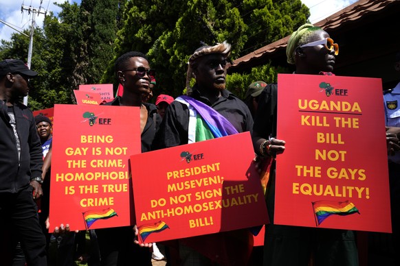 FILE - Activists hold placards during their picket against Uganda&#039;s anti-homosexuality bill at the Ugandan High Commission in Pretoria, South Africa on April 4, 2023. Uganda&#039;s president Yowe ...