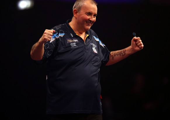 LONDON, ENGLAND - DECEMBER 30: Phil Taylor of England celebrates winning his third round match against Kim Huybrechts of Belgium during the William Hill PDC World Darts Championships on Day Ten at Ale ...