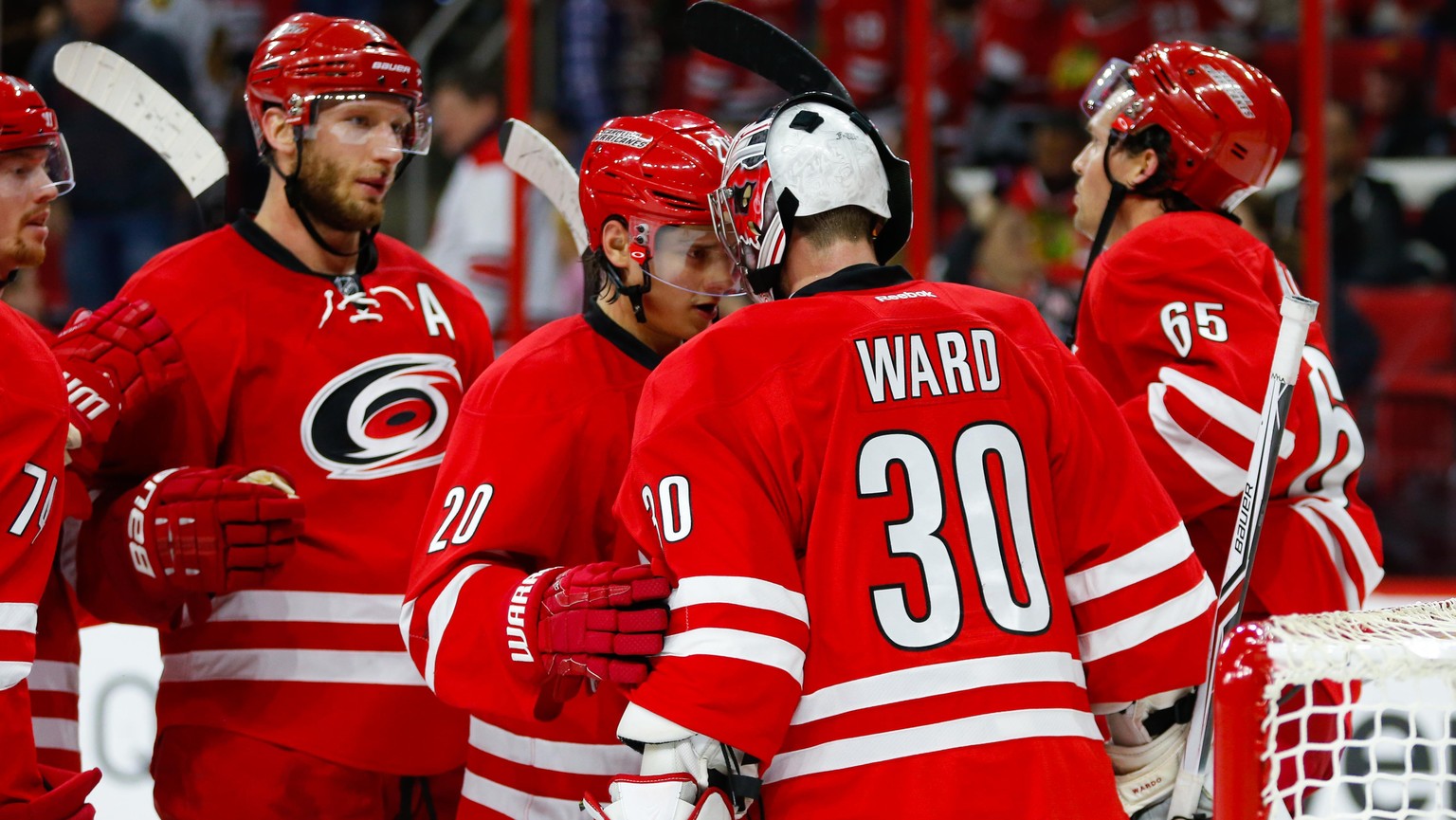 Dec 30, 2016; Raleigh, NC, USA; Carolina Hurricanes forward Sebastian Aho (20) and Hurricanes goalie Cam Ward (30) celebrate their victory against the Chicago Blackhawks at PNC Arena. The Carolina Hur ...