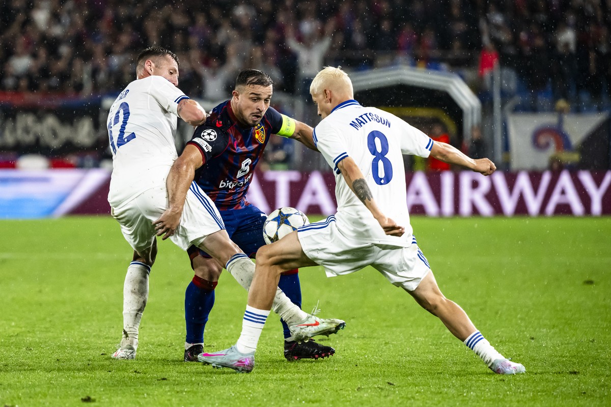 Basel's Xherdan Shaqiri, center, fights for the ball with Copenhagen's Lukas Lerager, left, and Copenhagen's Magnus Mattsson, right, during the UEFA Champions League play-off first leg  ...