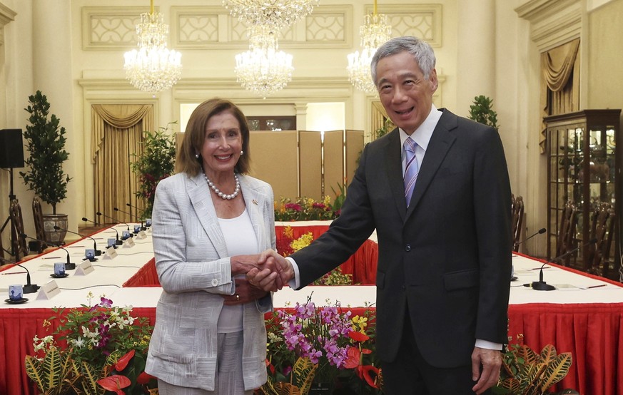 In this photo provided by Ministry of Communications and Information, Singapore, U.S. House Speaker Nancy Pelosi, left, and Prime Minister Lee Hsien Loong shake hands at the Istana Presidential Palace ...