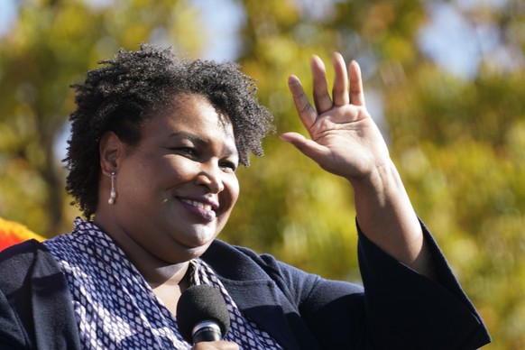 FILE - In this Monday, Nov. 2, 2020, file photo, Stacey Abrams speaks to Biden supporters as they wait for former President Barack Obama to arrive and speak at a campaign rally for Biden at Turner Fie ...