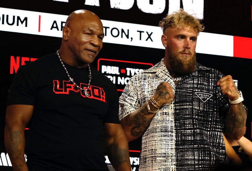 epa11554632 Former heavyweight boxing champion Mike Tyson (L) and YouTuber and professional boxer Jake Paul pose during a pre-fight press conference at the Javits Center in New York, New York, USA, 18 ...